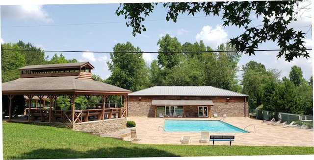 pool featuring a gazebo, a yard, a patio, and fence