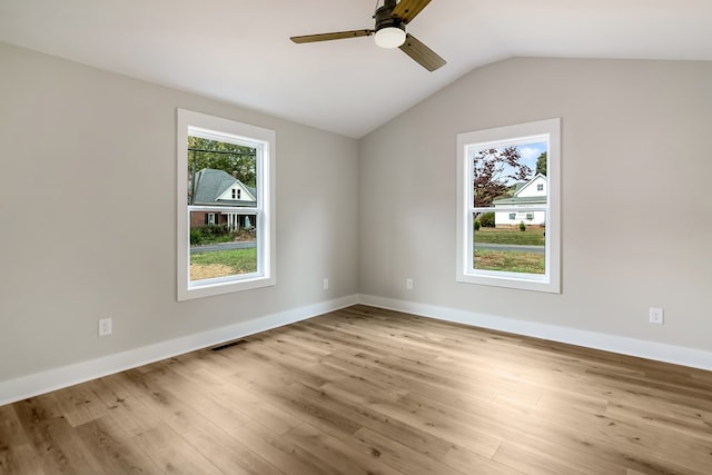 spare room with vaulted ceiling, light hardwood / wood-style flooring, and ceiling fan