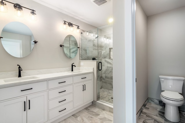 bathroom featuring vanity, toilet, and a shower with shower door