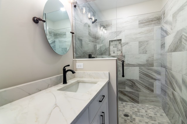 bathroom featuring vanity and a shower with shower door