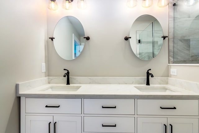 bathroom with vanity and a shower