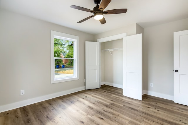 unfurnished bedroom featuring a closet, light hardwood / wood-style floors, and ceiling fan