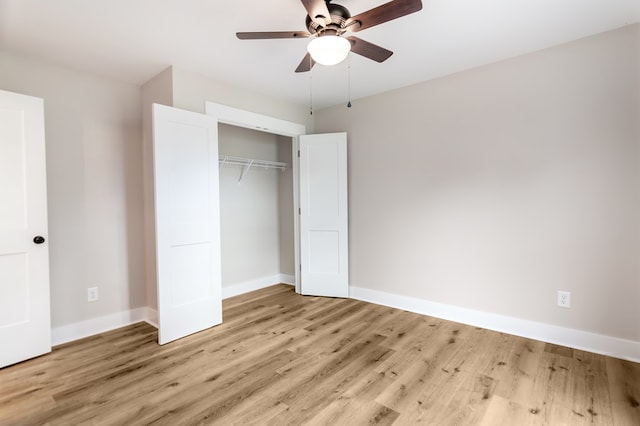 unfurnished bedroom with a closet, light wood-type flooring, and ceiling fan