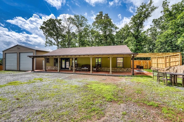 1529 Cedar View Ln, Hiawassee, GA 30546 - rear view of property with an outdoor structure, stone siding, and gravel driveway