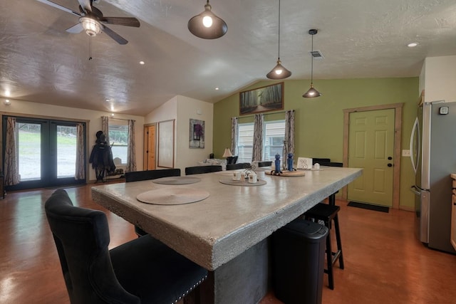 1529 Cedar View Ln, Hiawassee, GA 30546 - kitchen featuring freestanding refrigerator, vaulted ceiling, open floor plan, a breakfast bar area, and ceiling fan