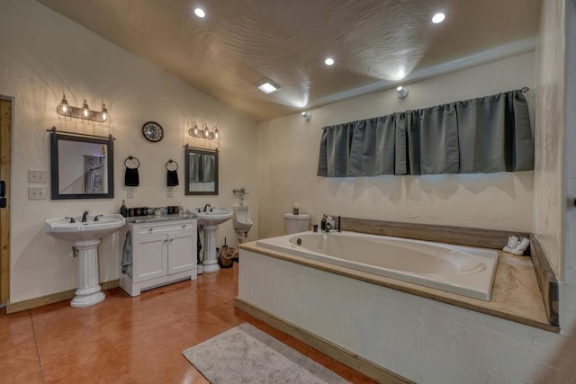 1529 Cedar View Ln, Hiawassee, GA 30546 - bathroom with a garden tub, recessed lighting, vaulted ceiling, two sinks, and finished concrete floors