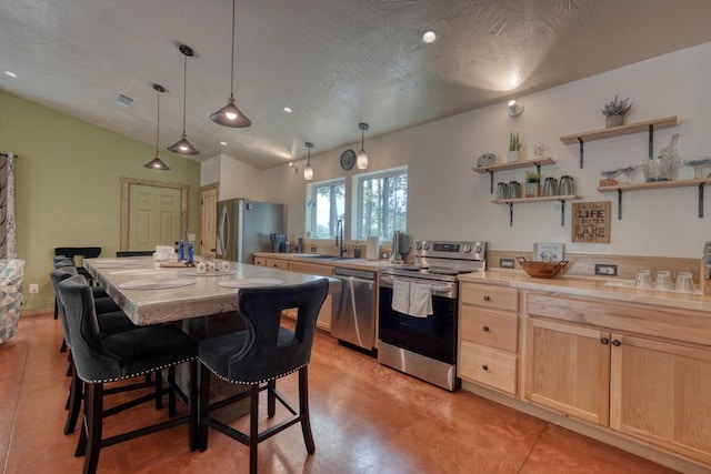 1529 Cedar View Ln, Hiawassee, GA 30546 - kitchen featuring stainless steel appliances, light brown cabinets, light countertops, a kitchen breakfast bar, and finished concrete floors
