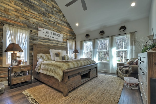 bedroom with ceiling fan, high vaulted ceiling, and dark hardwood / wood-style flooring