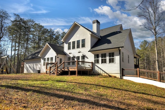 back of property featuring a wooden deck and a lawn