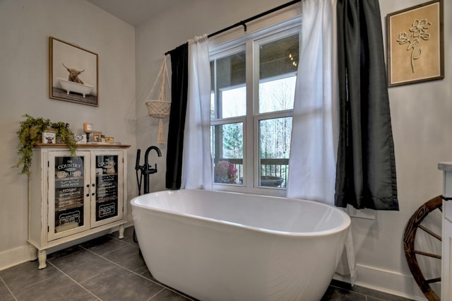 bathroom featuring tile patterned flooring and a bathing tub