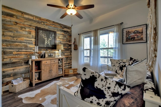 interior space with ceiling fan and dark hardwood / wood-style flooring