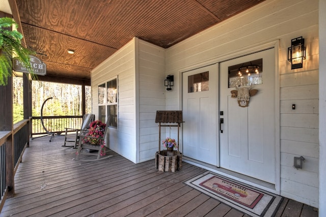 view of exterior entry with a porch