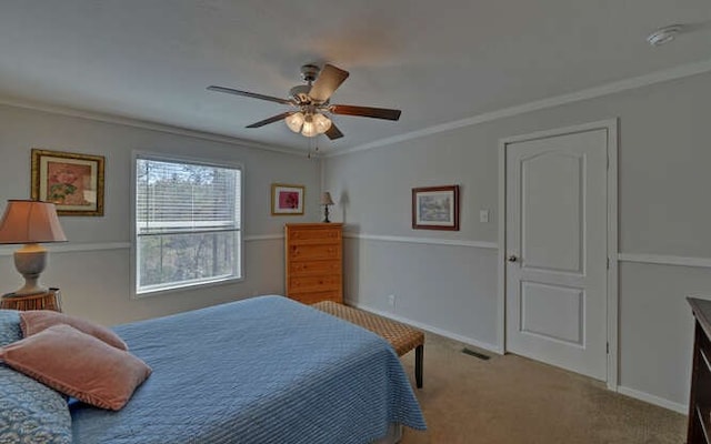 bedroom with ornamental molding, carpet floors, baseboards, and a ceiling fan