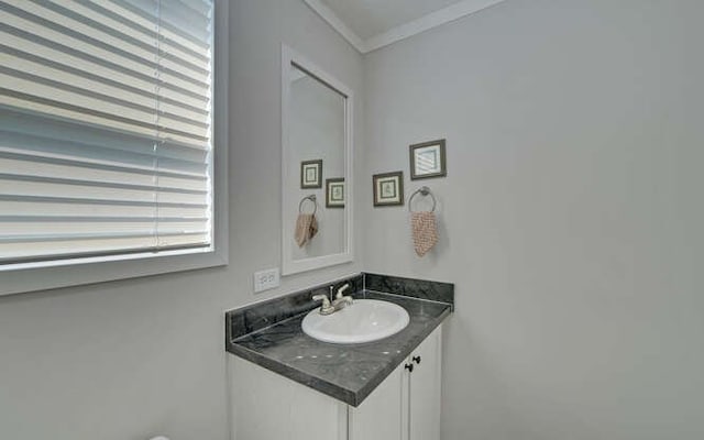 bathroom with ornamental molding and vanity