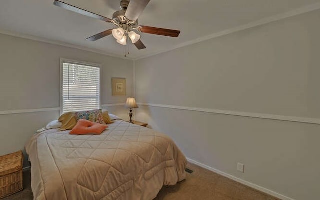 bedroom featuring ceiling fan, ornamental molding, carpet, and baseboards