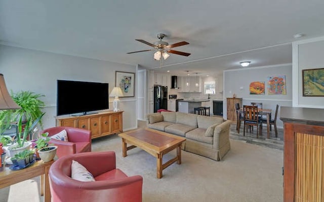 living room featuring a ceiling fan and light colored carpet