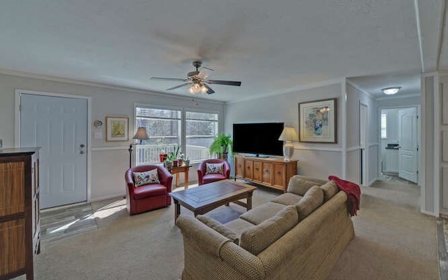 carpeted living room featuring ceiling fan and crown molding