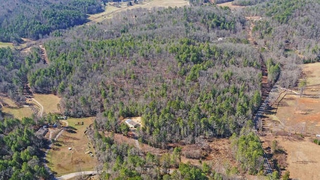 drone / aerial view featuring a forest view