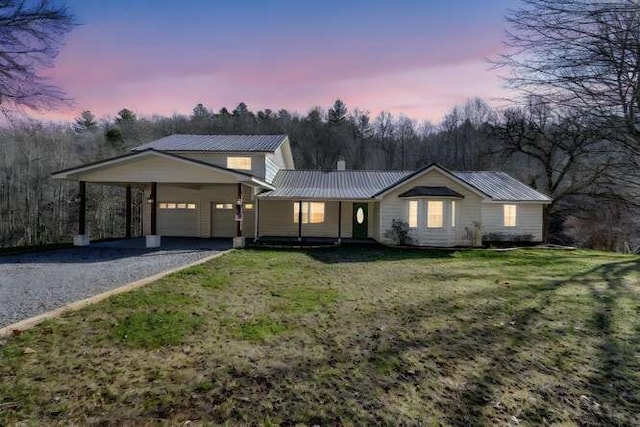 view of front of property with a yard and a carport