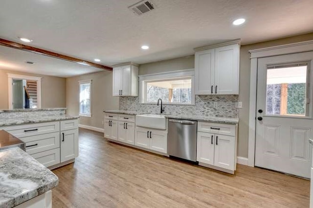 kitchen featuring dishwasher, white cabinets, sink, light stone countertops, and light hardwood / wood-style floors