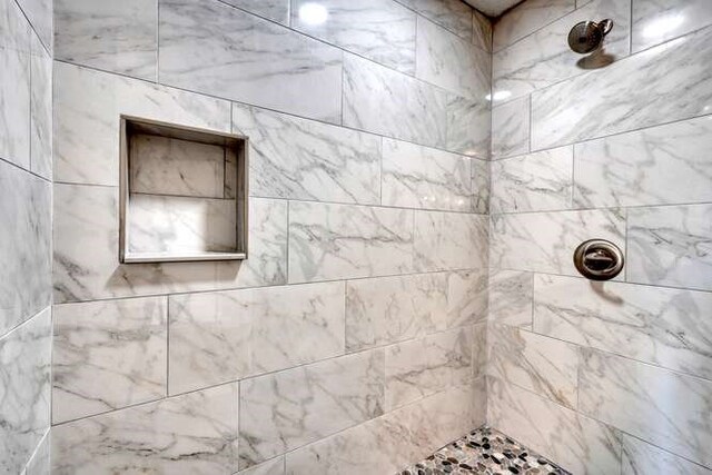 bathroom with a tile shower