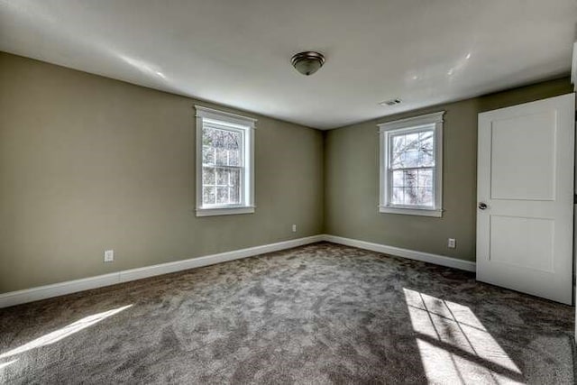 empty room featuring dark carpet