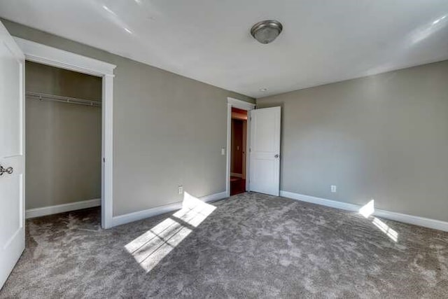 unfurnished bedroom featuring carpet floors and a closet