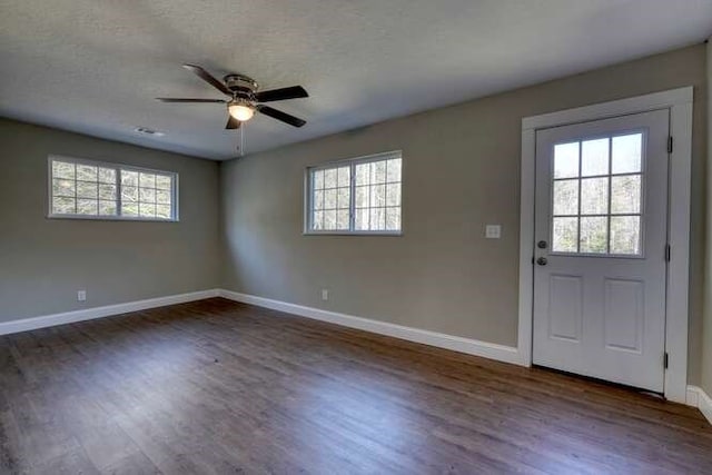 foyer featuring a textured ceiling, dark hardwood / wood-style flooring, and ceiling fan