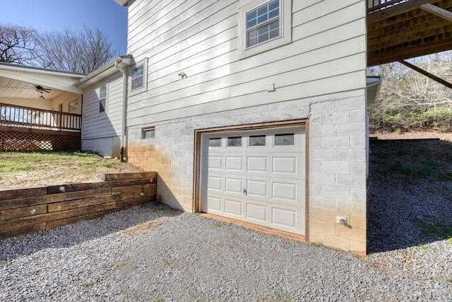 view of side of property with a garage and a wooden deck