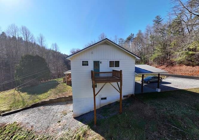 view of side of property with a lawn and a carport