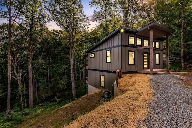 property exterior at dusk with cooling unit