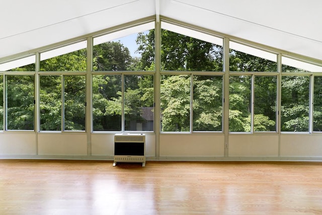 unfurnished sunroom with lofted ceiling and heating unit