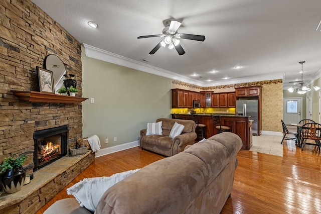 1726 Watercrest Way # B, Young Harris, GA 30582 - living area featuring ceiling fan, ornamental molding, baseboards, a stone fireplace, and light wood-style floors