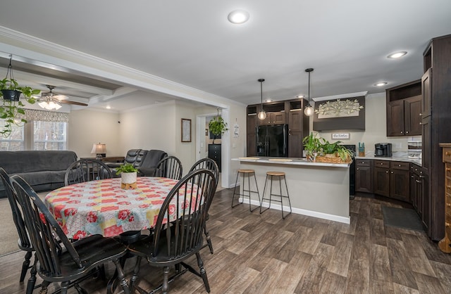 dining area featuring ornamental molding, dark wood finished floors, and recessed lighting