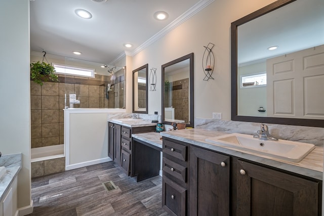 full bathroom with plenty of natural light, a sink, and crown molding