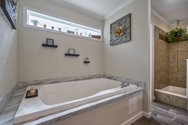 bathroom featuring a tile shower, ornamental molding, and a garden tub