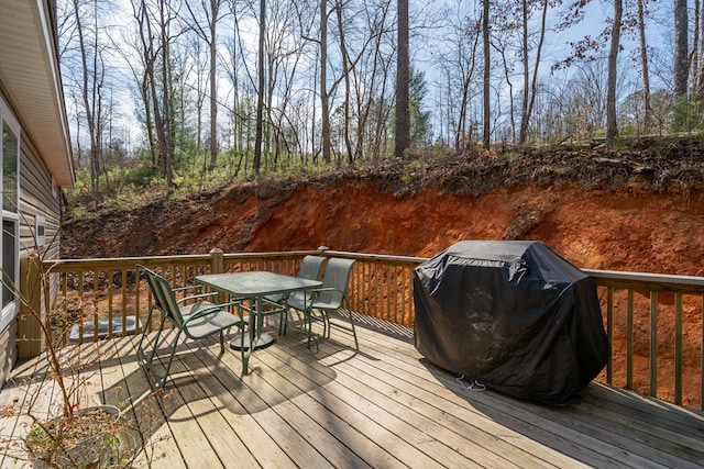 deck with outdoor dining area and area for grilling