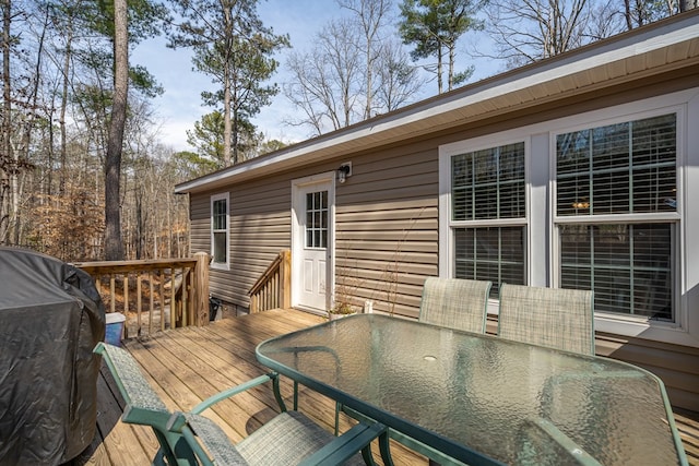 deck featuring outdoor dining area and area for grilling