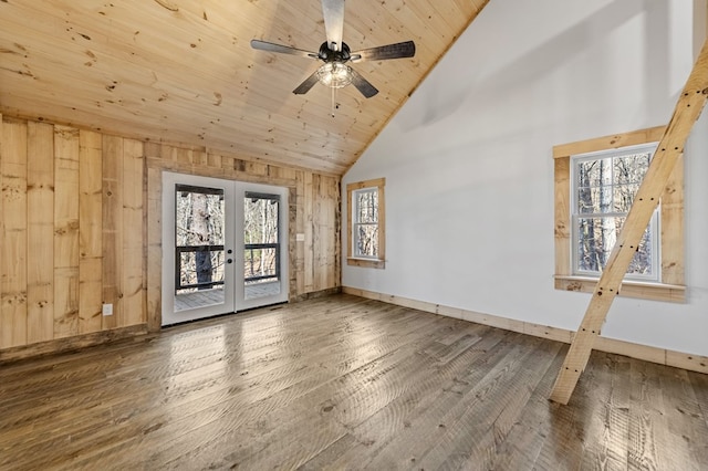 empty room featuring hardwood / wood-style floors, wood ceiling, french doors, high vaulted ceiling, and wood walls