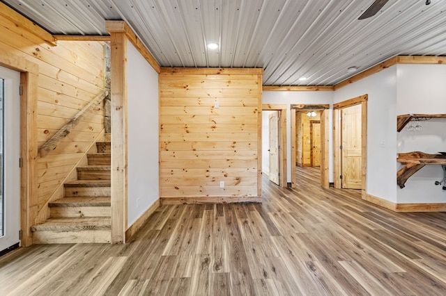 interior space with wood walls and hardwood / wood-style floors