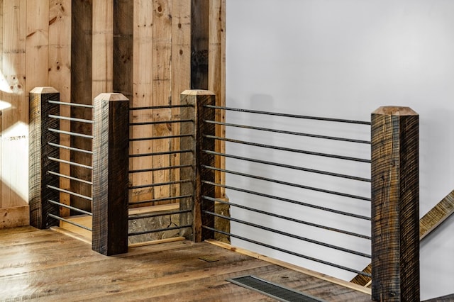 room details featuring hardwood / wood-style flooring and wood walls