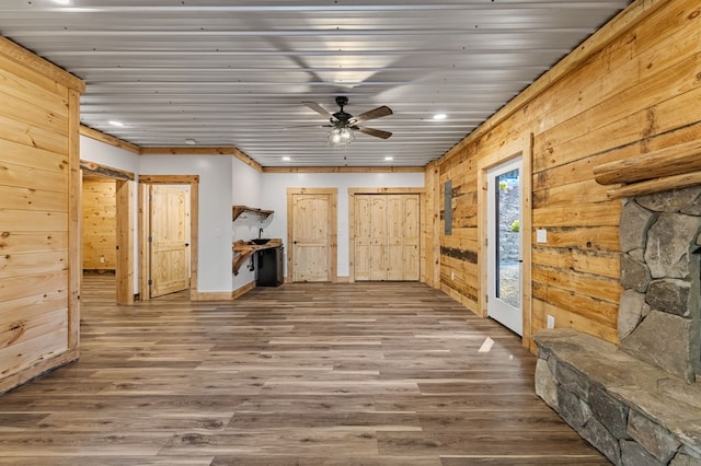 interior space featuring wood-type flooring, wooden walls, and wood ceiling