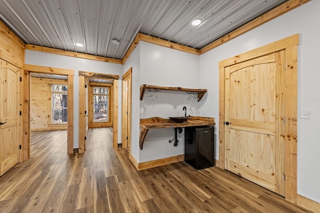 interior space featuring wooden ceiling, dark wood-type flooring, and ornamental molding