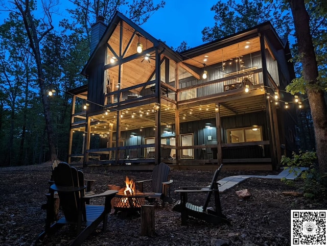 241 Lees Ride, Mccaysville, GA 30555 - rear view of property featuring board and batten siding, an outdoor fire pit, a chimney, and a balcony