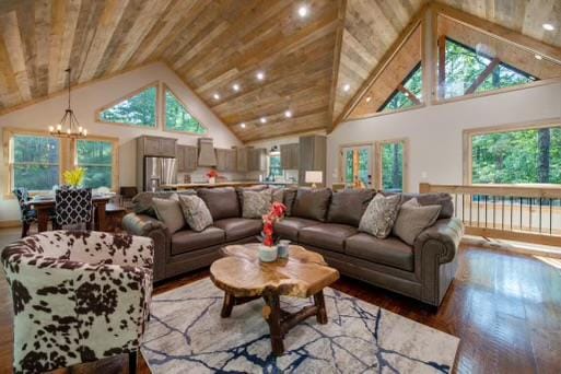 241 Lees Ride, Mccaysville, GA 30555 - living room with a chandelier, wood finished floors, plenty of natural light, and high vaulted ceiling