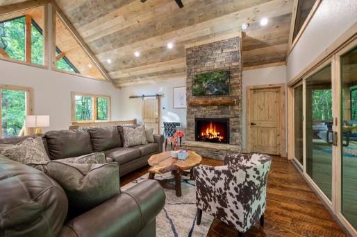241 Lees Ride, Mccaysville, GA 30555 - living area with high vaulted ceiling, wood finished floors, a stone fireplace, recessed lighting, and beam ceiling