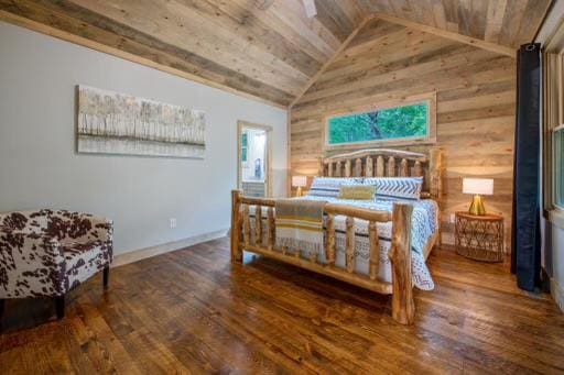 241 Lees Ride, Mccaysville, GA 30555 - bedroom with vaulted ceiling, wood finished floors, wood walls, wooden ceiling, and baseboards