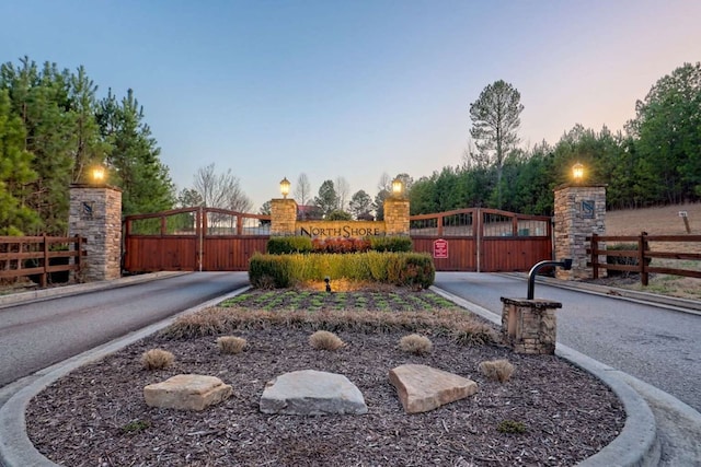 exterior space featuring a gate and curbs