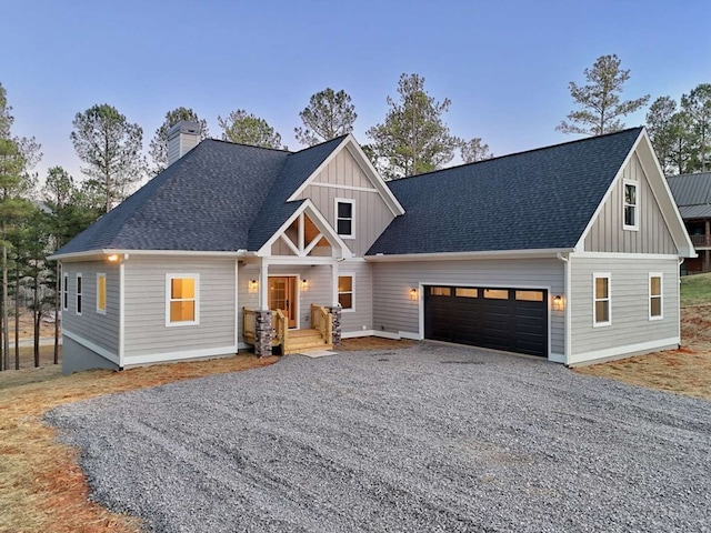 view of front of property featuring a chimney, board and batten siding, a garage, gravel driveway, and roof with shingles