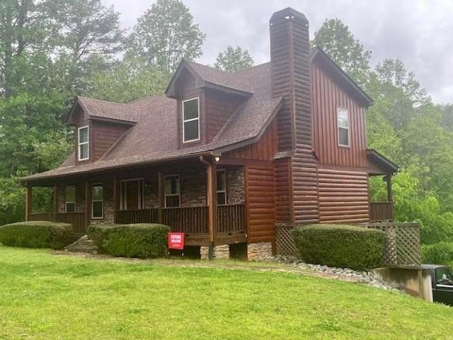600 Mill Ridge Rd, Hiawassee, GA 30546 - rear view of house with a porch, a lawn, faux log siding, and a chimney